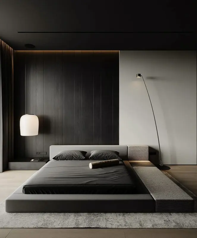 Reference bedroom with a low platform bed, dark wall panels and concealed warm lighting.