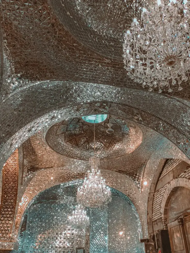 Reference photograph looking into an intricate mirrored ceiling and chandelier.