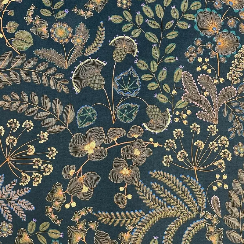Deep navy textile with botanical motifs in muted gold, green, blue and rose.